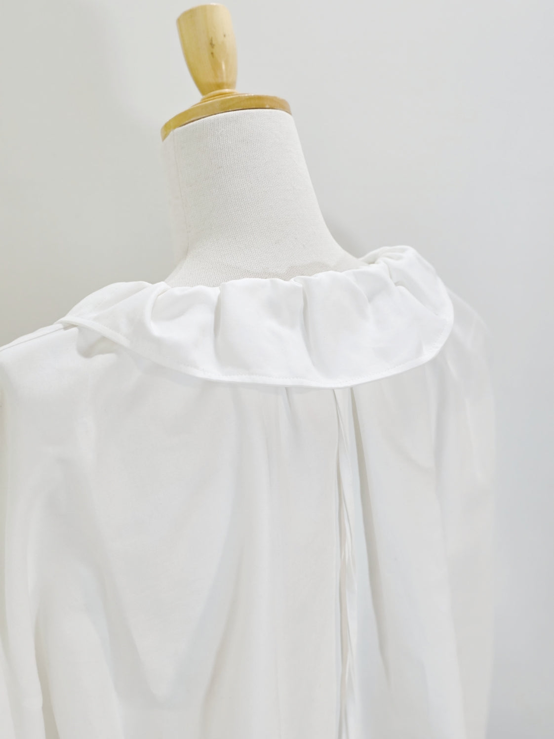 ENFOLD HIGH-NECK BLOUSE