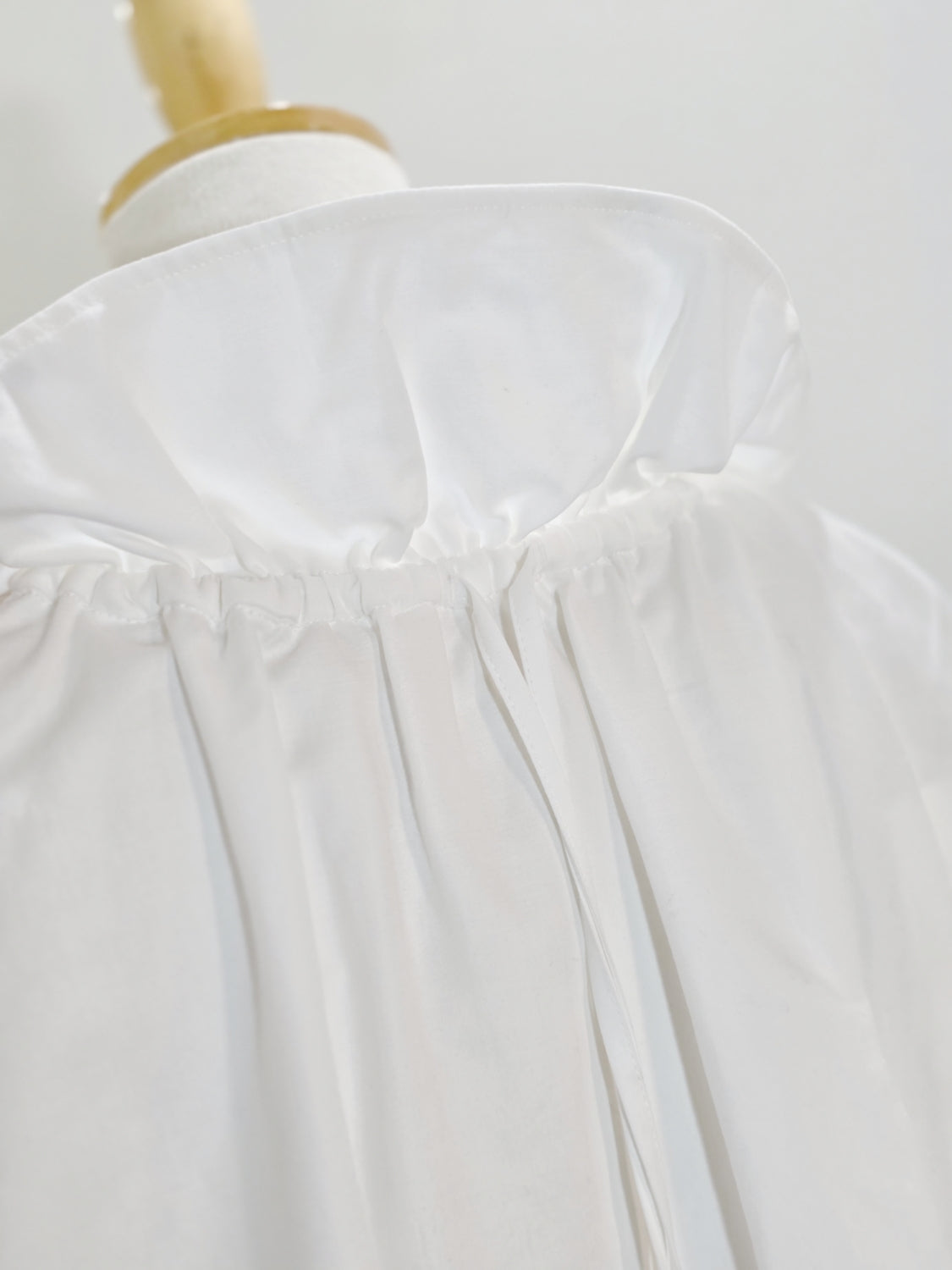 ENFOLD HIGH-NECK BLOUSE